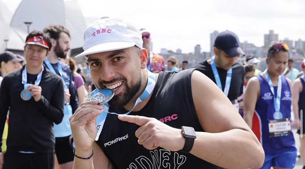 The Sydney Run Club founder, Emilio Khatis, celebrating his finisher medal after the 2024 TCS Sydney Marathon