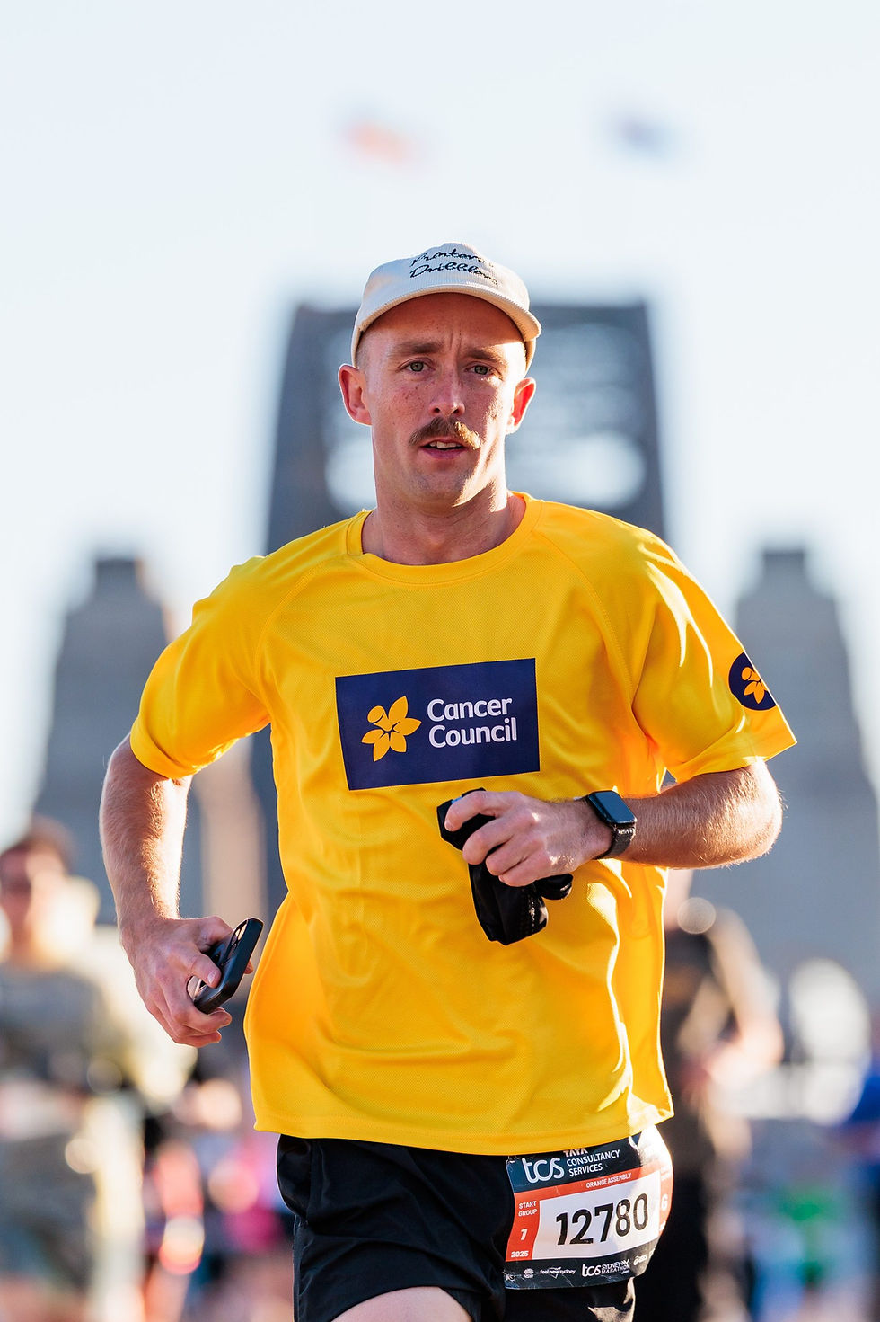 Man in Cancer Council shirt running marathon running in Sydney