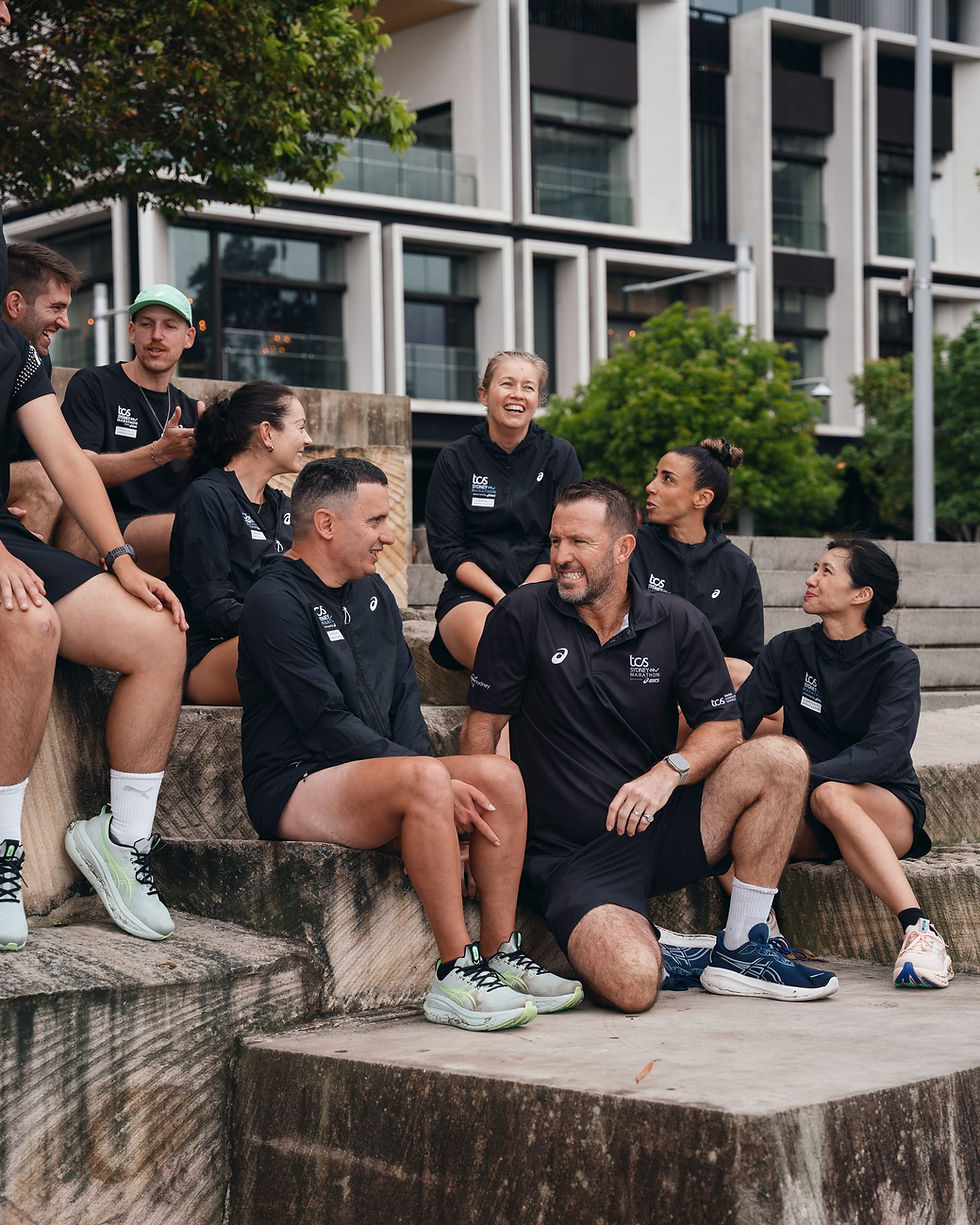 TCS Sydney Marathon Run Club members chatting on stone steps