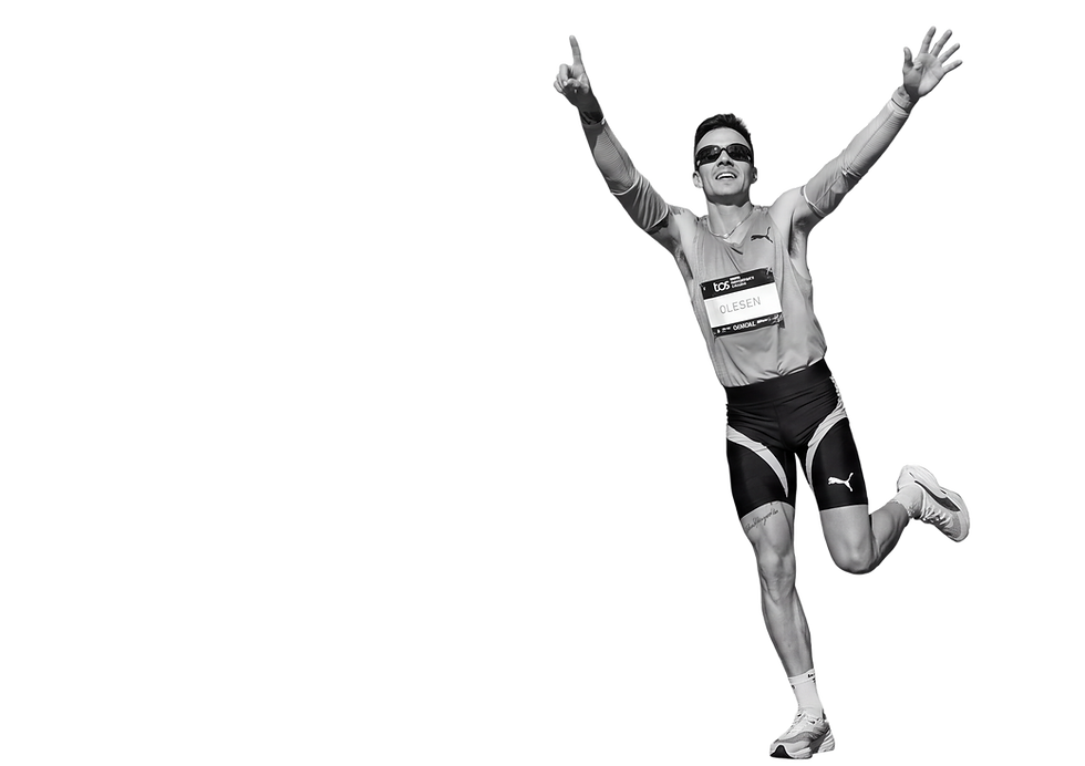 Athlete celebrating at the finish line of a high-performance race.