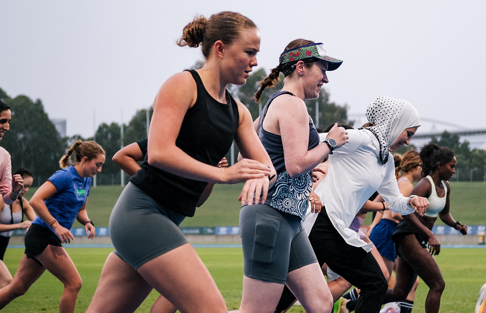 A group of diverse women athletes starting a race